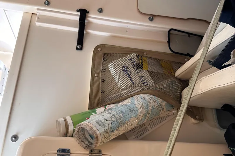 Slide: The Image of 2004 Grady-White Gulfstream 232 interior with stored maps and manuals. - 21