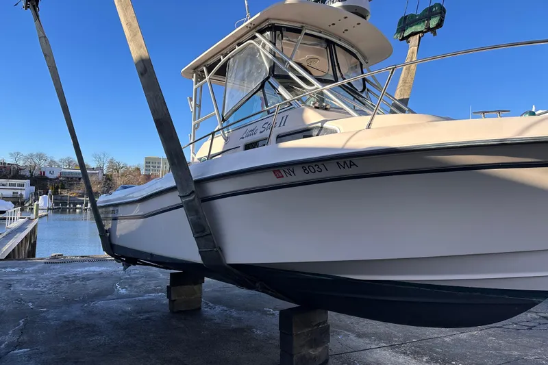 Slide: The Image of 2004 Grady-White Gulfstream 232 boat on lift, dockside view. - 22