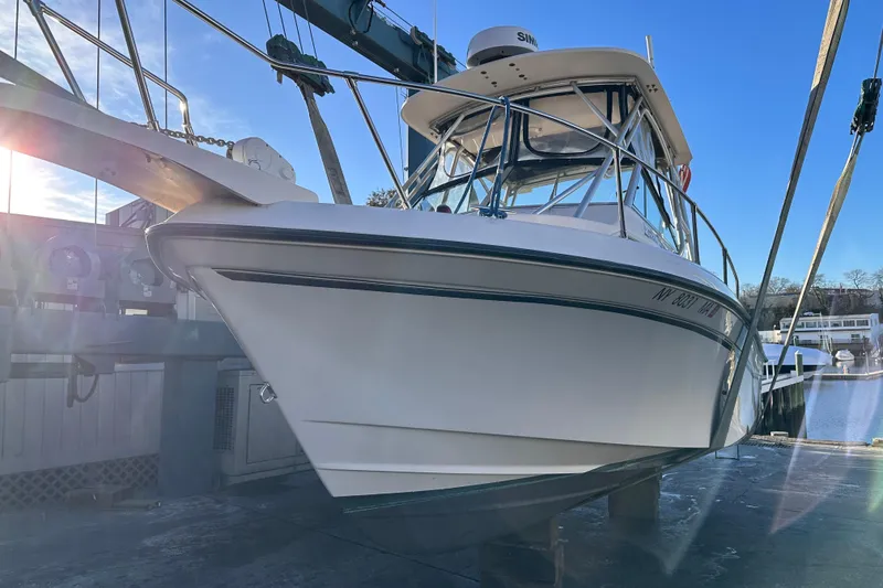 Slide: The Image of 2004 Grady-White Gulfstream 232 boat docked under clear blue sky. - 23