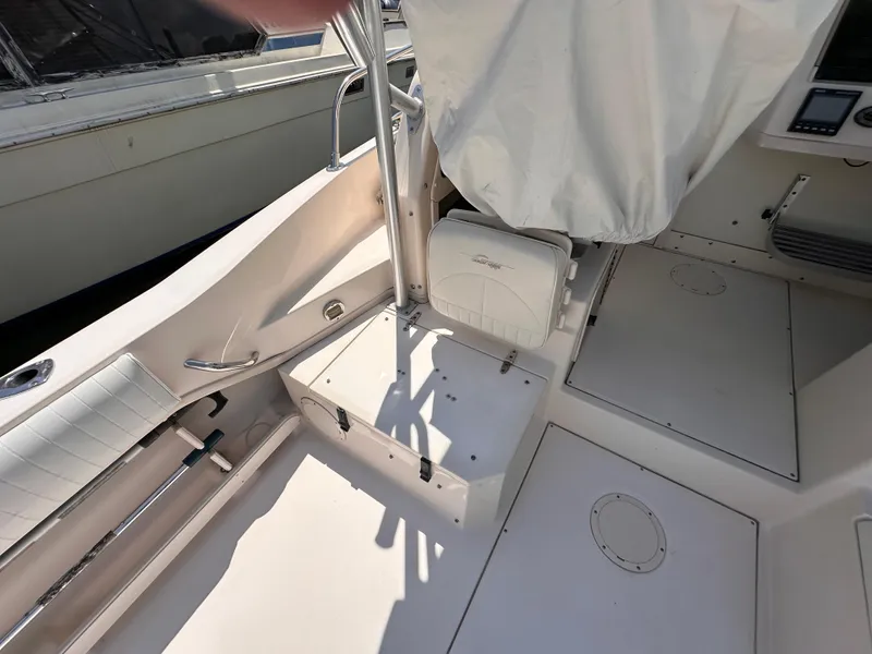 Slide: The Image of 2004 Grady-White Gulfstream 232 boat interior with covered seats and steering wheel. - 5