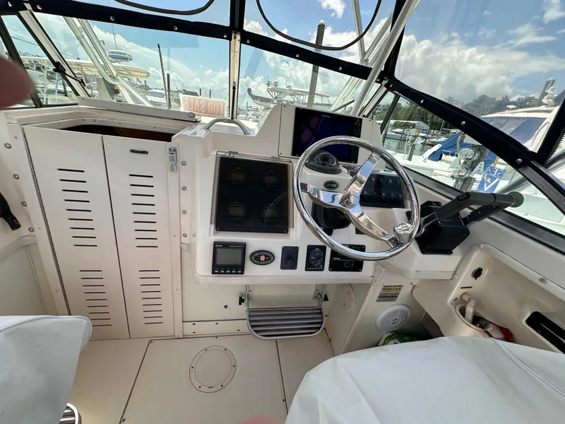 Slide: The Image of 2004 Grady-White Gulfstream 232 boat interior with seating and storage compartments. - 6