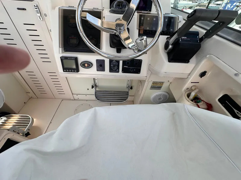 Slide: The Image of 2004 Grady-White Gulfstream 232 boat helm with steering wheel and control panel. - 9