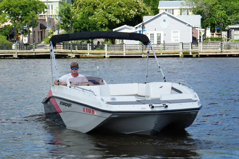 Slide: The Image of 2021 Starcraft SVX 171 OB boat cruising on a river with a scenic backdrop. - 11