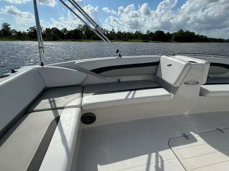 Slide: The Image of 2021 Starcraft SVX 171 OB boat interior with white seating, on a calm lake. - 2