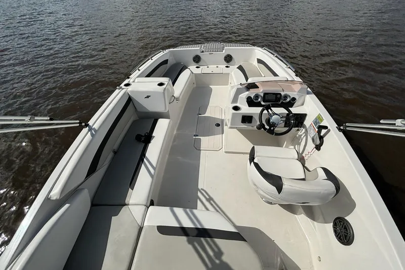 Slide: The Image of 2021 Starcraft SVX 171 OB boat interior with seating and steering console on water. - 7