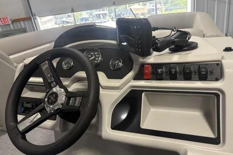 Slide: The Image of 2025 Godfrey Xperience 2286 SBX boat dashboard with steering wheel and control panel. - 12