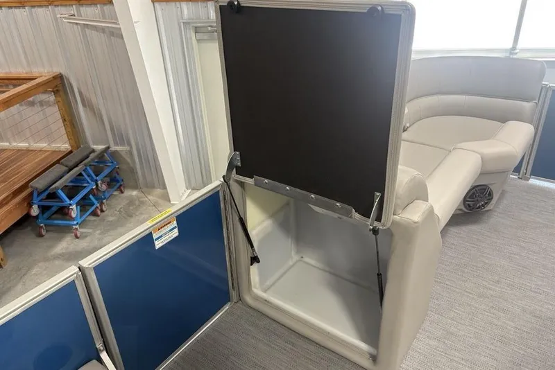 Slide: The Image of 2025 Godfrey Xperience 2286 SBX interior with storage compartment and seating area. - 13