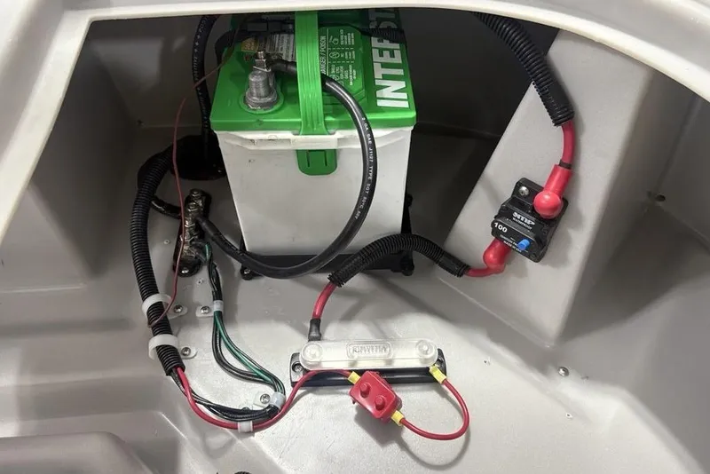 Slide: The Image of Battery compartment of 2025 Godfrey Xperience 2286 SBX with wiring and circuit breaker. - 18