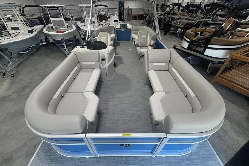 Slide: The Image of 2025 Godfrey Xperience 2286 SBX pontoon boat with spacious seating in showroom. - 21