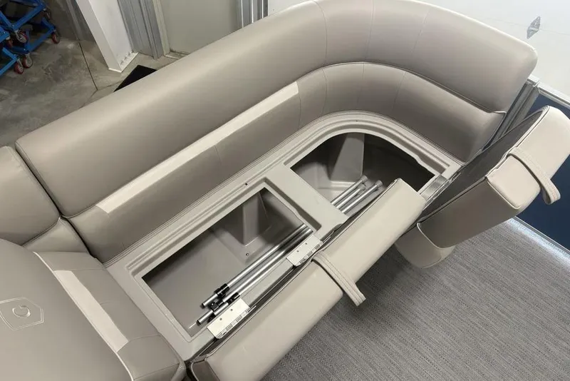 Slide: The Image of 2025 Godfrey Xperience 2286 SBX boat interior with open storage compartment and sleek seating. - 5