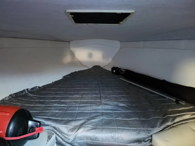 Slide: The Image of Interior cabin of a 2003 Baja 24 H2X Boss boat with a bed and hatch. - 5