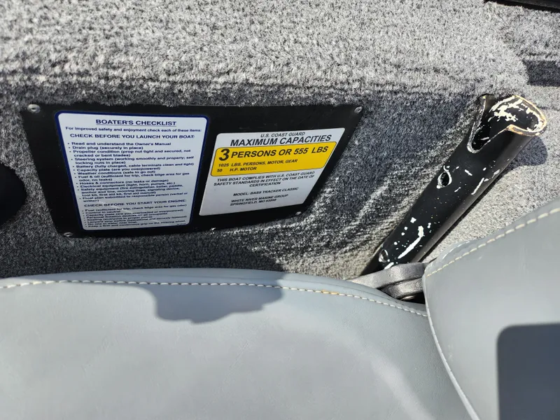 Slide: The Image of 2021 Tracker Bass Tracker Classic XL capacity label, seating for three, 555 lbs limit. - 12