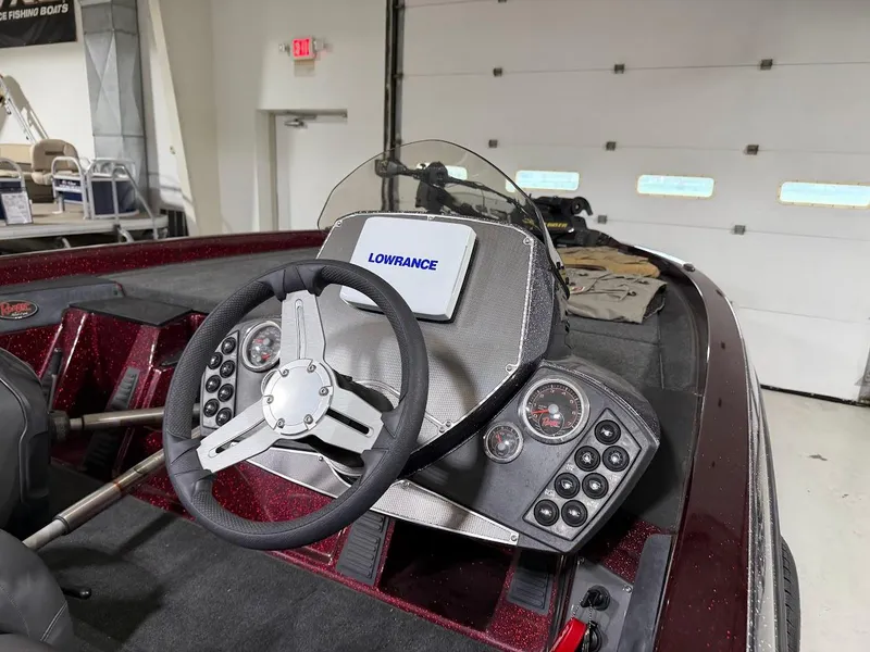 Slide: The Image of 2014 Ranger 118c boat dashboard with Lowrance electronics and steering wheel. - 11