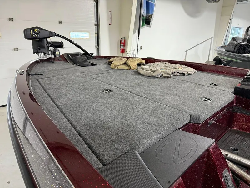 Slide: The Image of 2014 Ranger 118c boat interior with carpeted deck and fishing gear. - 5