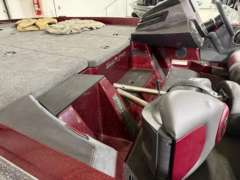 Slide: The Image of 2014 Ranger 118c boat interior with red accents and gray seating. - 6