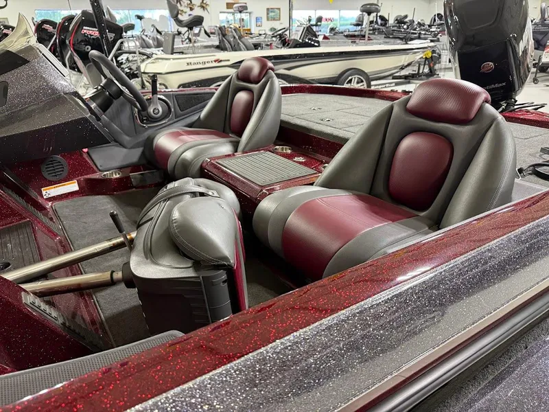 Slide: The Image of 2014 Ranger 118c boat interior with red and gray seats, steering wheel, and dashboard. - 7