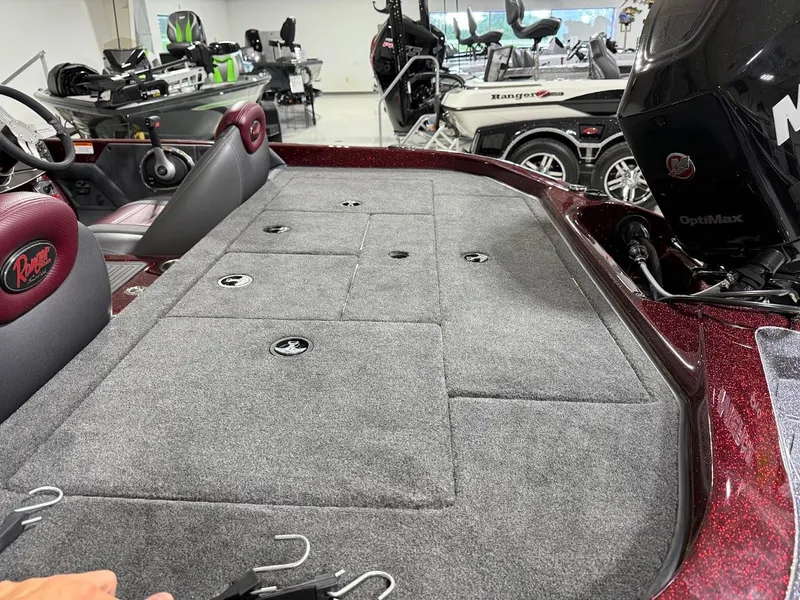 Slide: The Image of 2014 Ranger 118c boat interior with carpeted deck and OptiMax engine. - 9