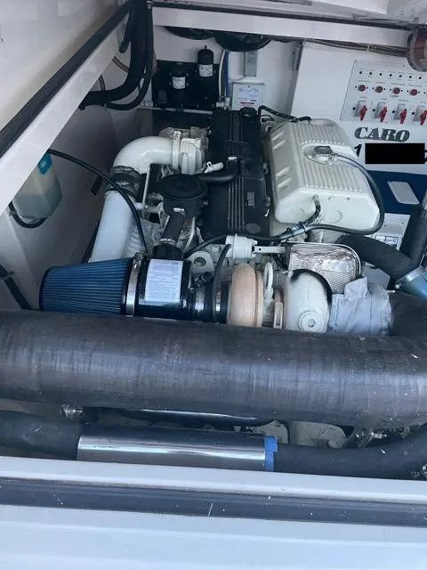 Slide: The Image of Engine compartment of a 2000 Cabo 35 Express boat, showcasing mechanical components. - 10