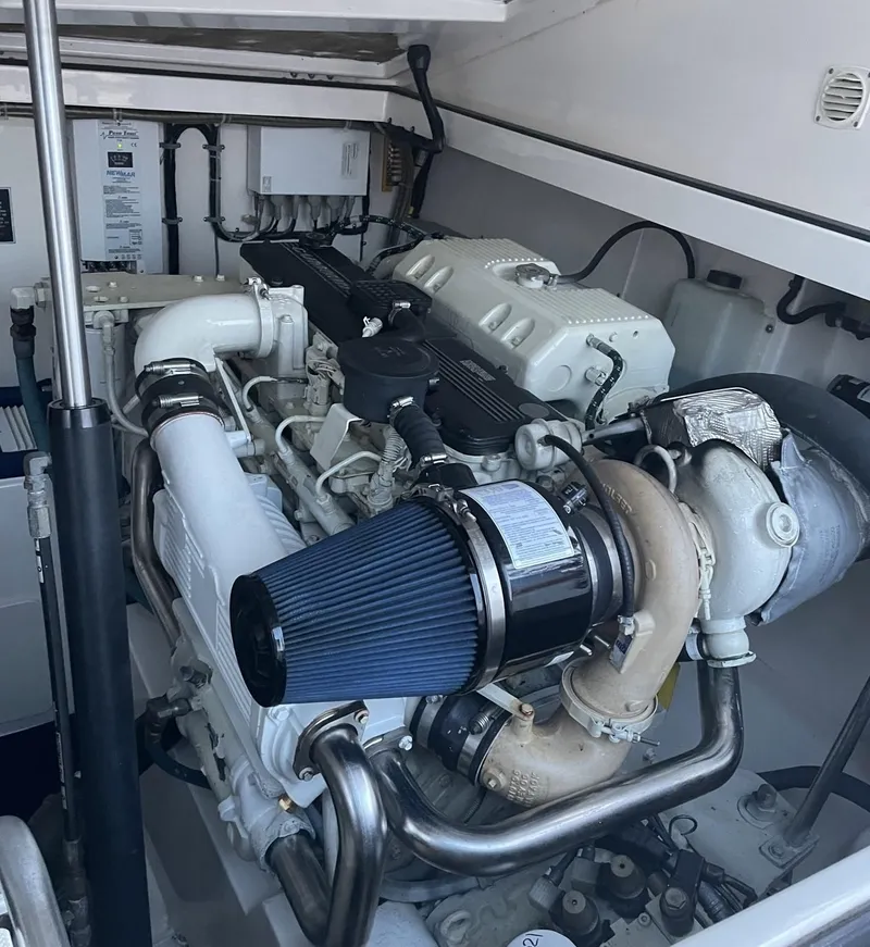 Slide: The Image of Engine compartment of a 2000 Cabo 35 Express boat, showcasing detailed mechanical components. - 11
