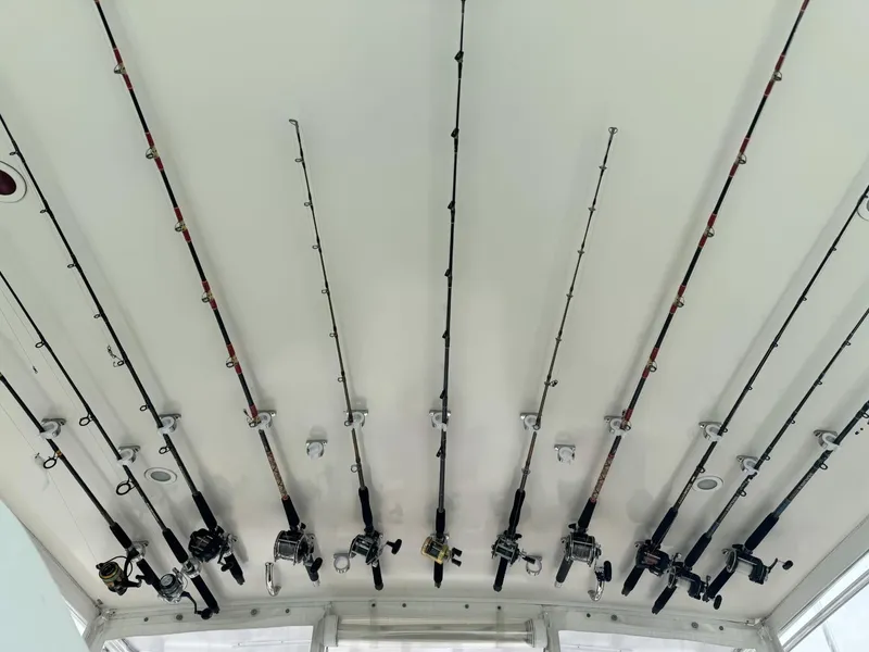 Slide: The Image of Fishing rods stored on a 2000 Cabo 35 Express boat ceiling. - 12