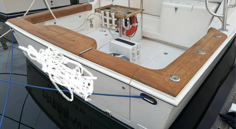 Slide: The Image of 2000 Cabo 35 Express boat with wooden deck and fishing equipment. - 2