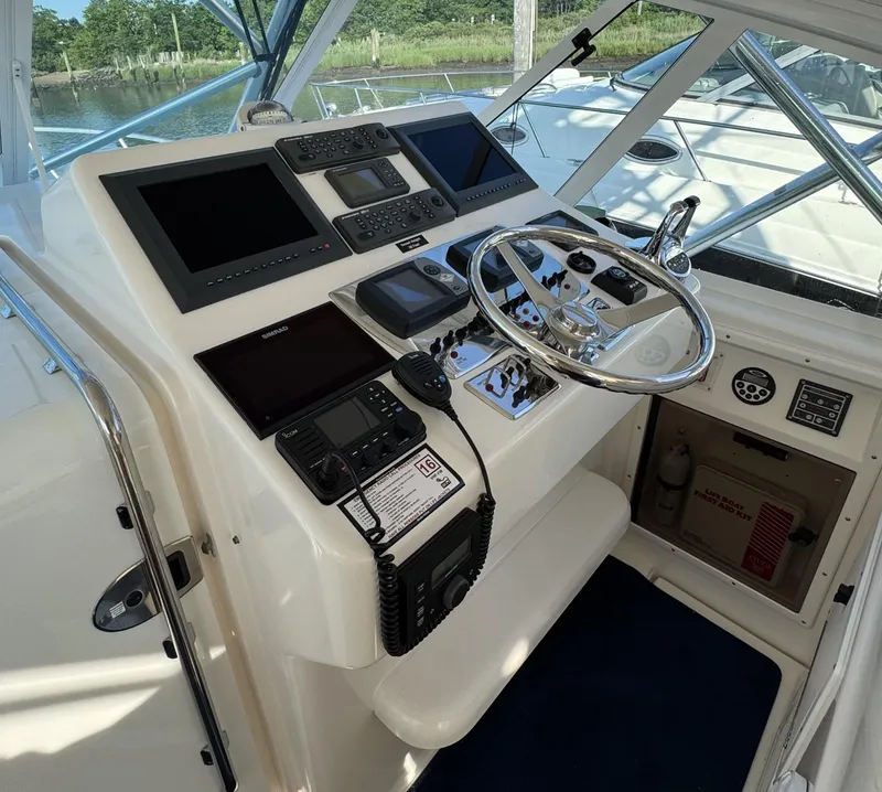 Slide: The Image of Helm of 2000 Cabo 35 Express boat with modern navigation equipment and steering wheel. - 3