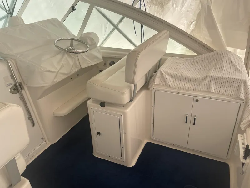 Slide: The Image of Interior of a 2000 Cabo 35 Express boat with covered helm and seating. - 5