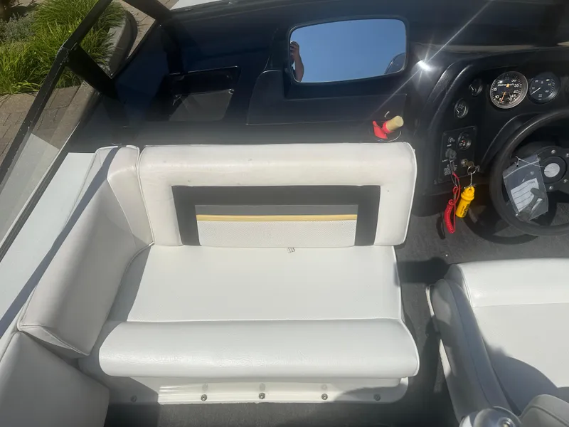 Slide: The Image of 1989 MasterCraft ProStar 190 interior with white seating and dashboard controls. - 10