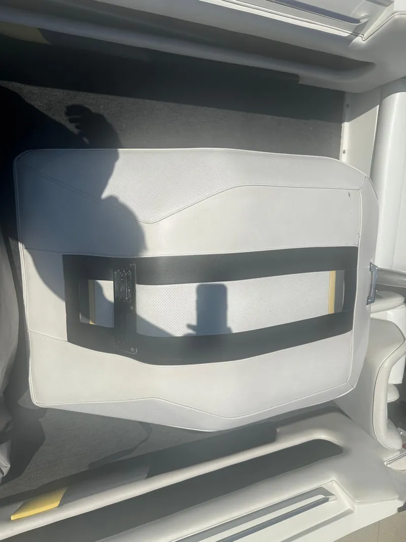 Slide: The Image of 1989 MasterCraft ProStar 190 boat seat with white upholstery and black strap. - 12