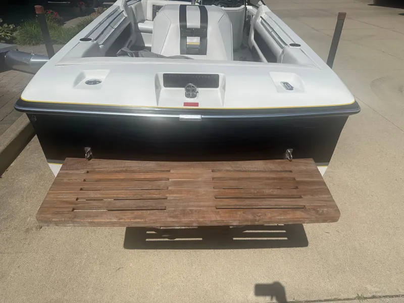 Slide: The Image of 1989 MasterCraft ProStar 190 boat with wooden swim platform, viewed from the rear. - 14