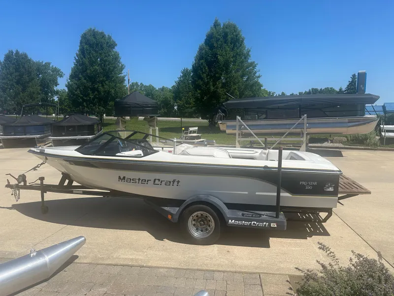 Slide: The Image of 1989 MasterCraft ProStar 190 boat on trailer, parked outdoors on a sunny day. - 3