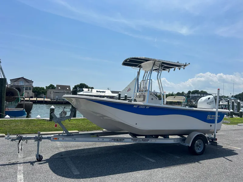 Slide: The Image of 2022 Carolina Skiff 19 LS boat on trailer by waterfront, sunny day. - 1