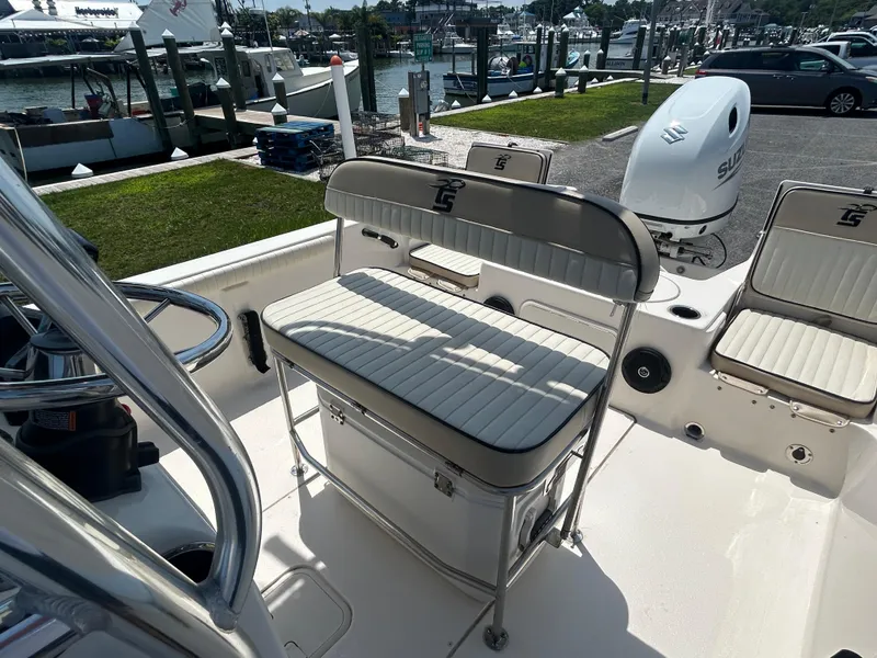Slide: The Image of 2022 Carolina Skiff 19 LS boat interior with seating and Suzuki outboard motor. - 19