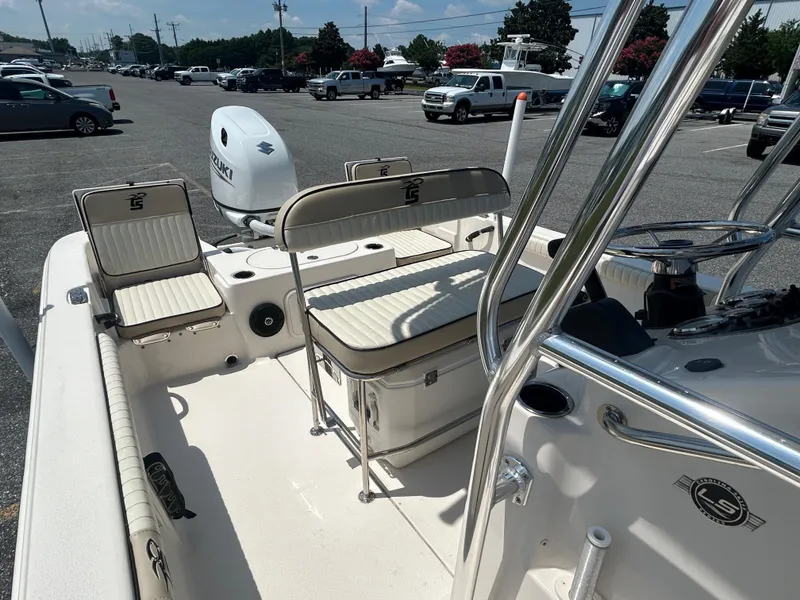 Slide: The Image of 2022 Carolina Skiff 19 LS boat interior with seating and Suzuki outboard motor. - 20