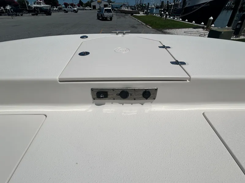 Slide: The Image of 2022 Carolina Skiff 19 LS boat deck with storage compartments and control panel. - 23