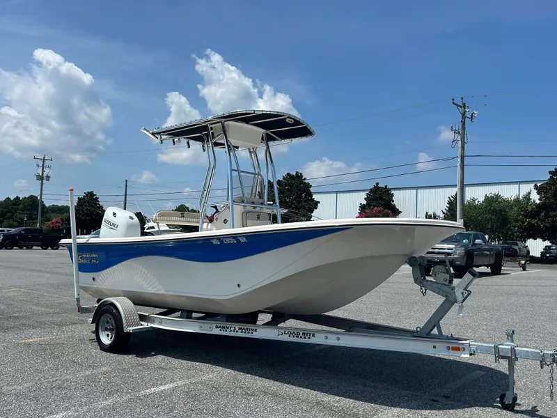 Slide: The Image of 2022 Carolina Skiff 19 LS boat on trailer under clear blue sky. - 5