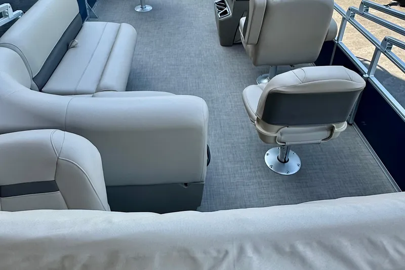 Slide: The Image of 2025 Sun Tracker Bass Buggy 18 DLX interior with beige seating and modern design. - 89