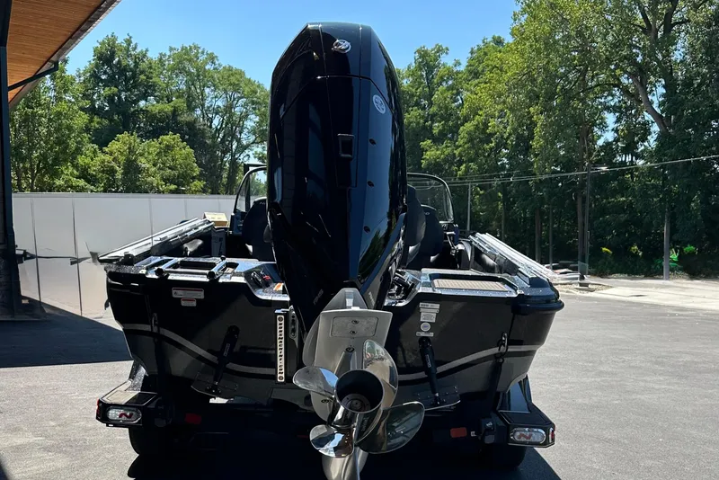 Slide: The Image of 2025 Nitro ZV21 Pro boat with powerful outboard motor, parked outdoors. - 3
