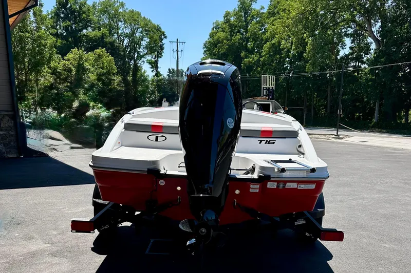 Slide: The Image of 2025 Tahoe T16 boat with outboard motor, parked outdoors on a sunny day. - 3