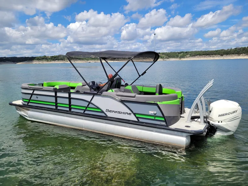 Slide: The Image of 2023 Berkshire 25RFX STS 3.0+ pontoon boat on a lake with Mercury engine. - 10