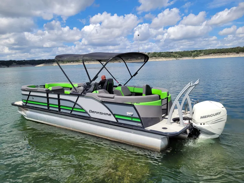 Slide: The Image of 2023 Berkshire 25RFX STS 3.0+ pontoon boat on a lake with Mercury engine. - 11