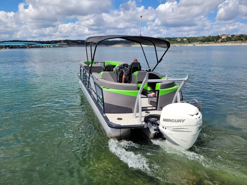 Slide: The Image of 2023 Berkshire 25RFX STS 3.0+ pontoon boat on clear water, featuring a Mercury engine. - 12