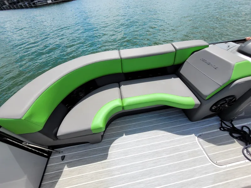 Slide: The Image of 2023 Berkshire 25RFX STS 3.0+ boat with green and gray seating on water. - 16