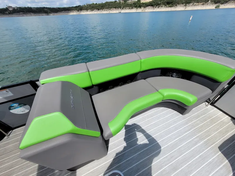 Slide: The Image of 2023 Berkshire 25RFX STS 3.0+ boat with green and gray seating on a lake. - 17