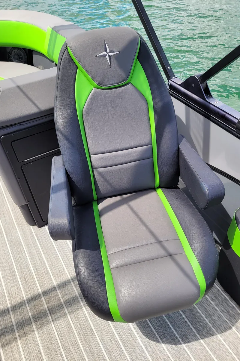 Slide: The Image of Captain's chair on 2023 Berkshire 25RFX STS 3.0+ pontoon boat, featuring gray and green upholstery. - 19