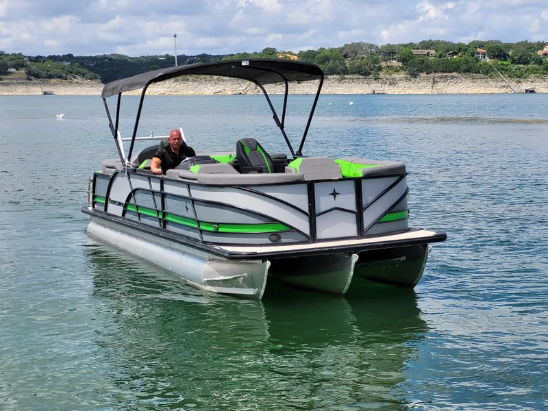 Slide: The Image of 2023 Berkshire 25RFX STS 3.0+ pontoon boat on a scenic lake. - 2