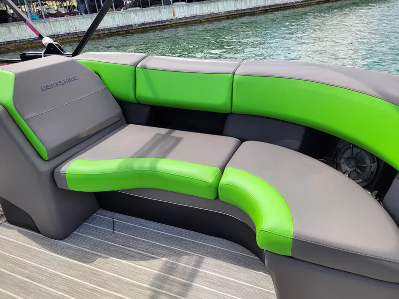 Slide: The Image of 2023 Berkshire 25RFX STS 3.0+ boat with green and gray seating by the water. - 21