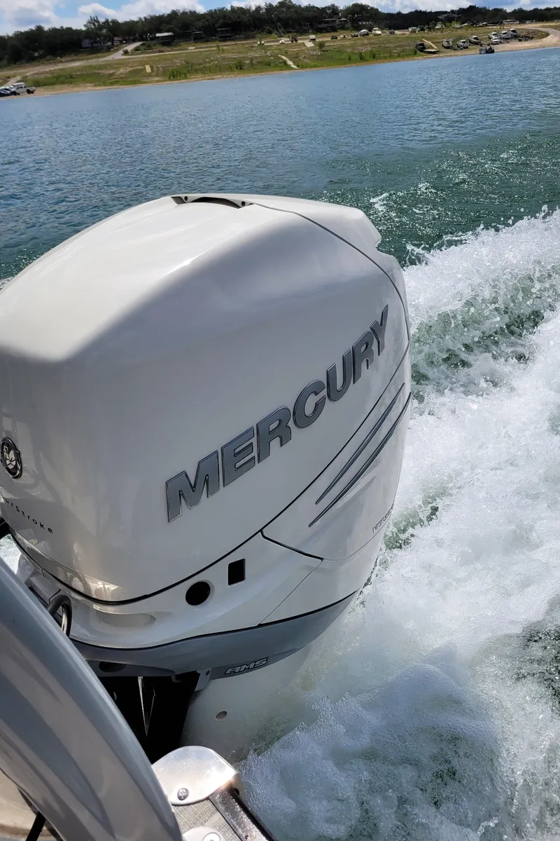 Slide: The Image of 2023 Berkshire 25RFX STS 3.0+ with Mercury outboard engine on a lake. - 23