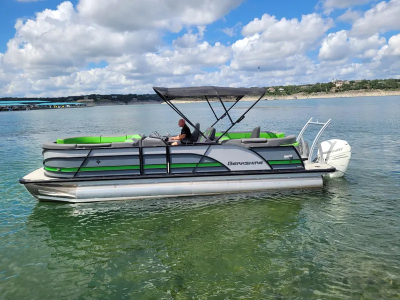 Slide: The Image of 2023 Berkshire 25RFX STS 3.0+ pontoon boat on a serene lake under a cloudy sky. - 7