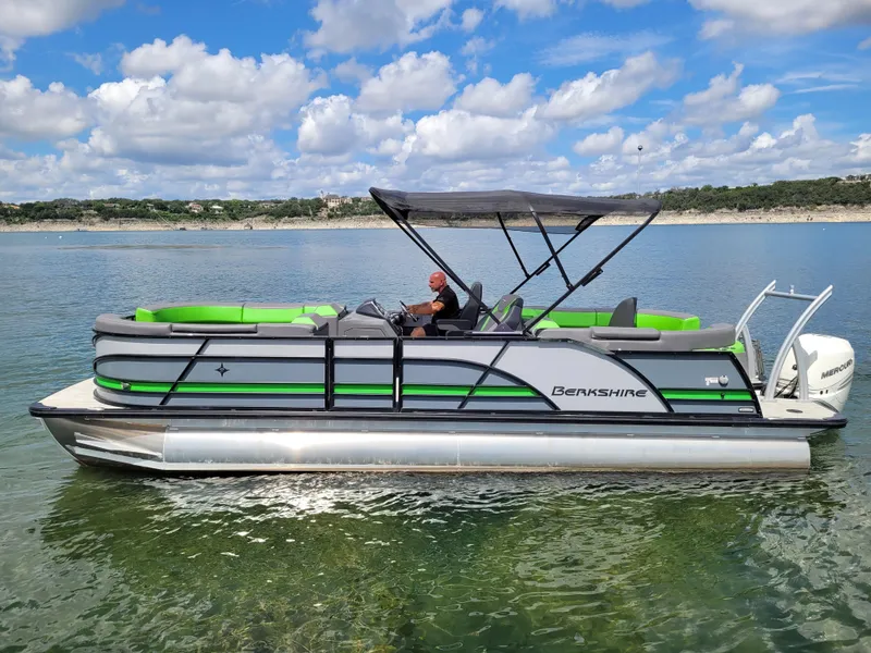 Slide: The Image of 2023 Berkshire 25RFX STS 3.0+ pontoon boat on a sunny lake with clear skies. - 9